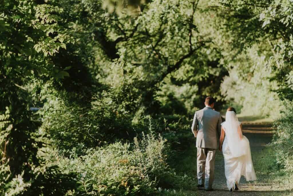 Bride and Groom Walking In Forest.