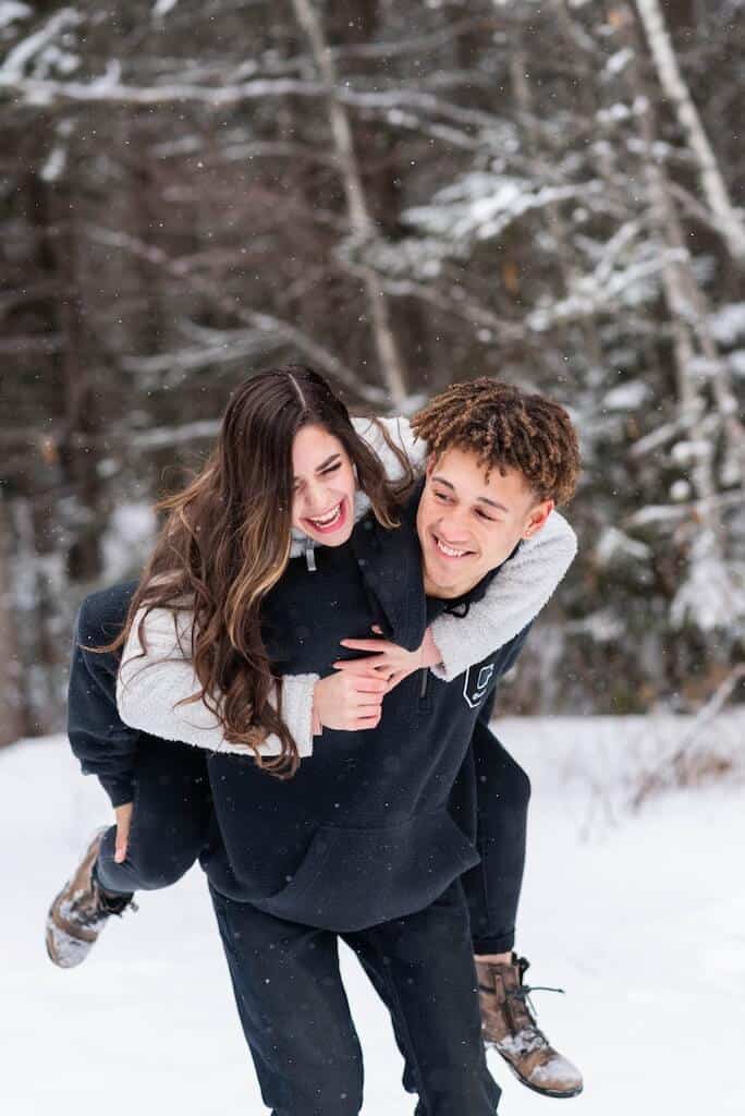 teenage couple playing in the snow on a winter date for teens 