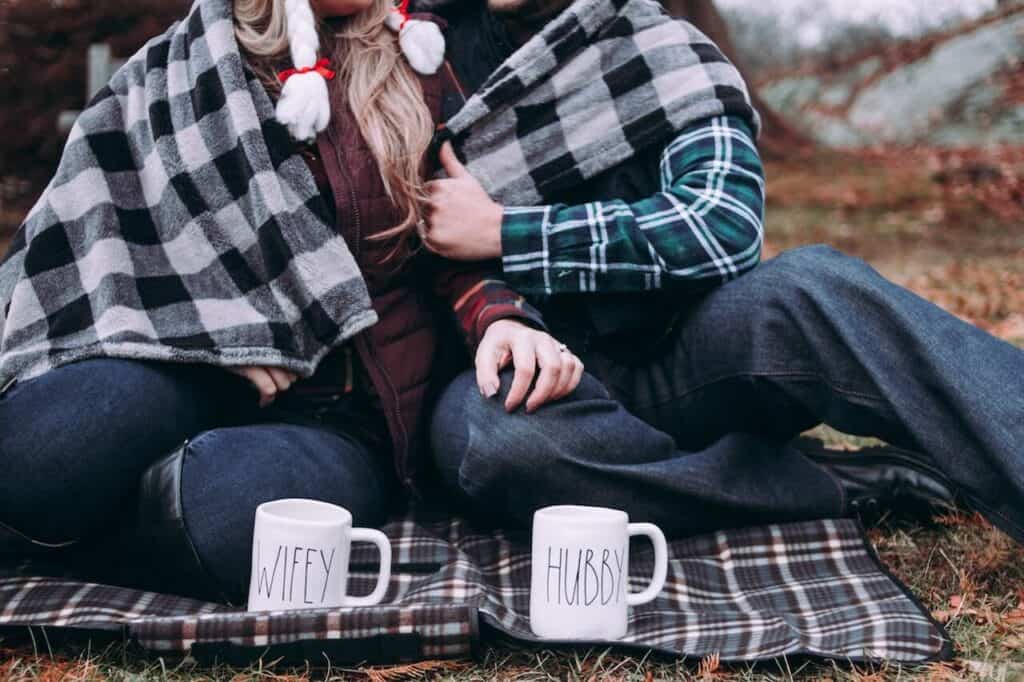 couple under blanket with wifey and hubby mugs