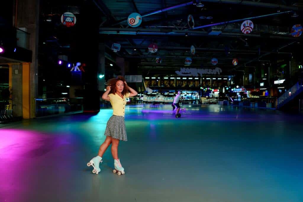 Girl standing in roller rink on a roller skate date. 