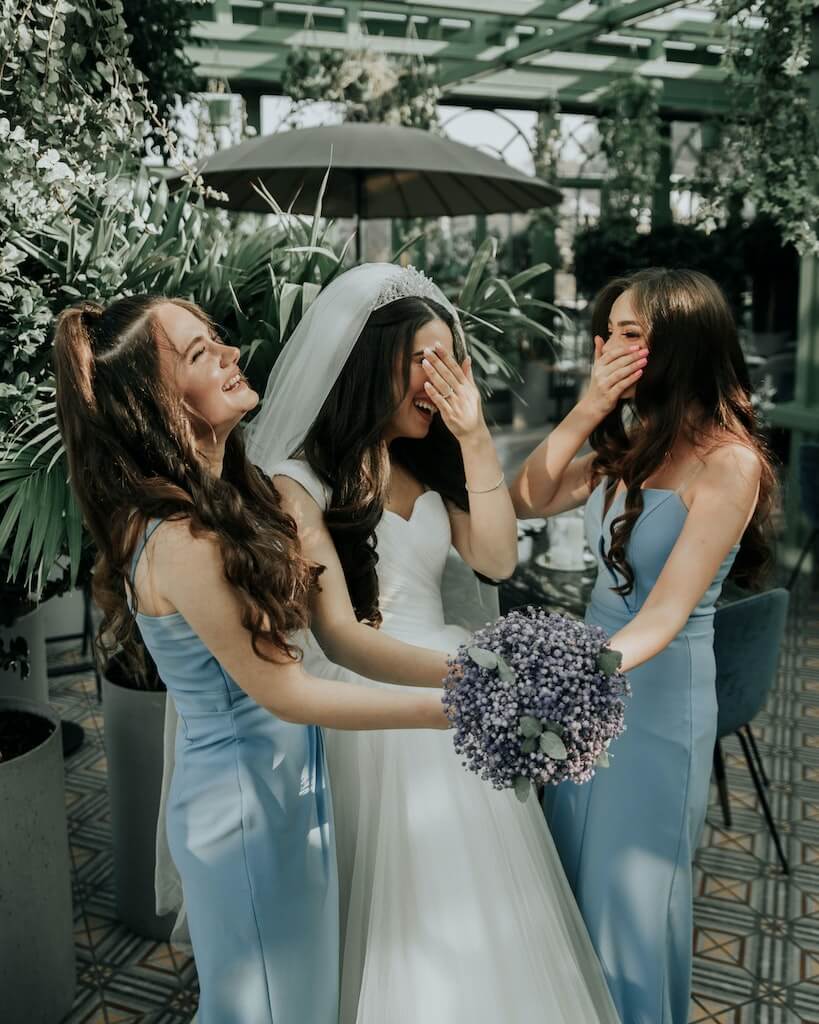 bride laughing with her bridesmaids.