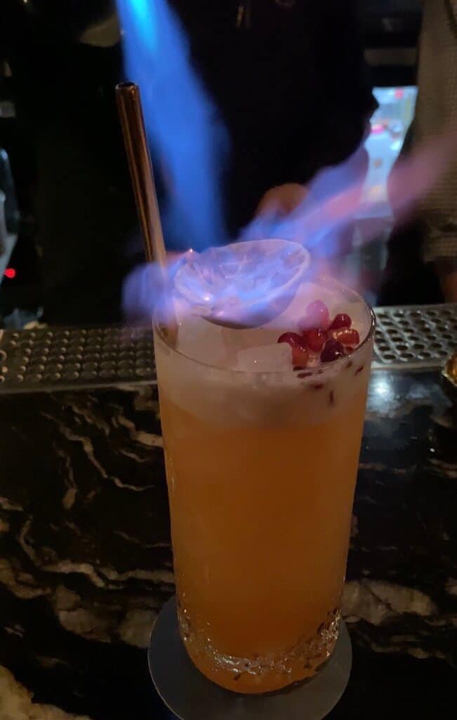smoking cocktail at a speakeasy date in Boston. 