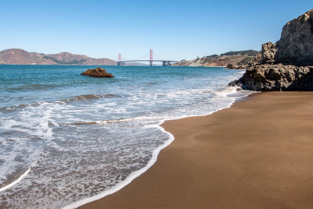 beach with view of Golden Gate Bridge. 