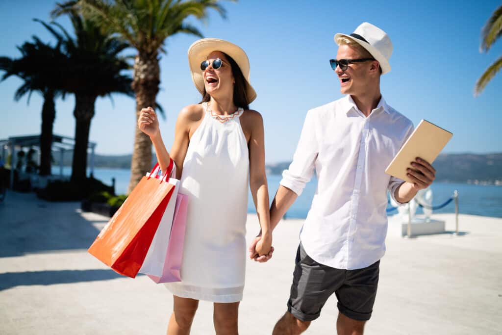 couple on summer vacation enjoying travel and shopping on the beach.