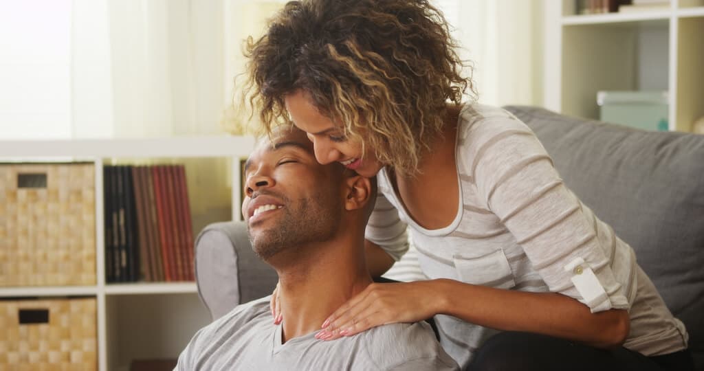 woman giving a man a shoulder massage. 