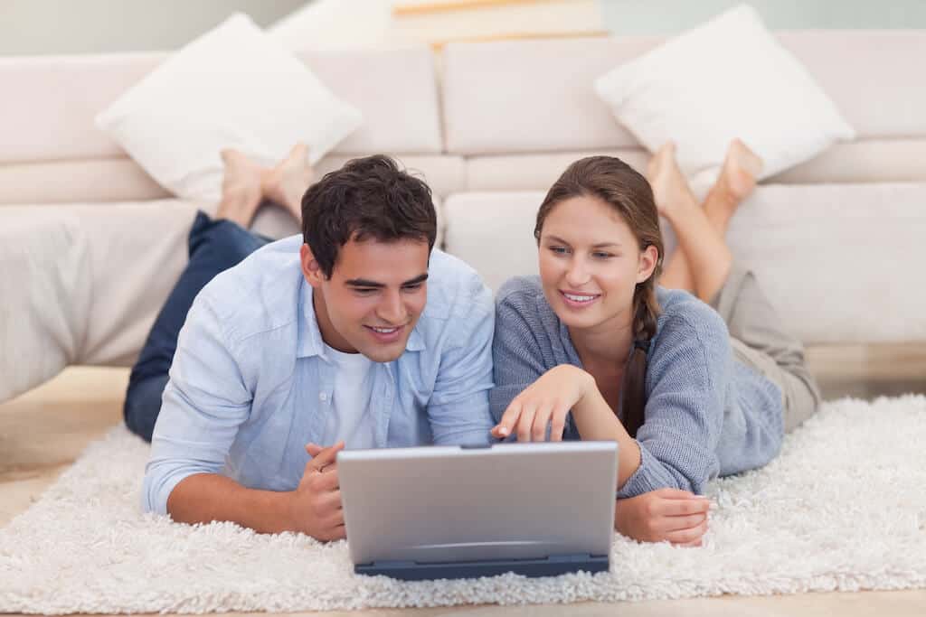 couple looking at computer reading questions for boyfriend.