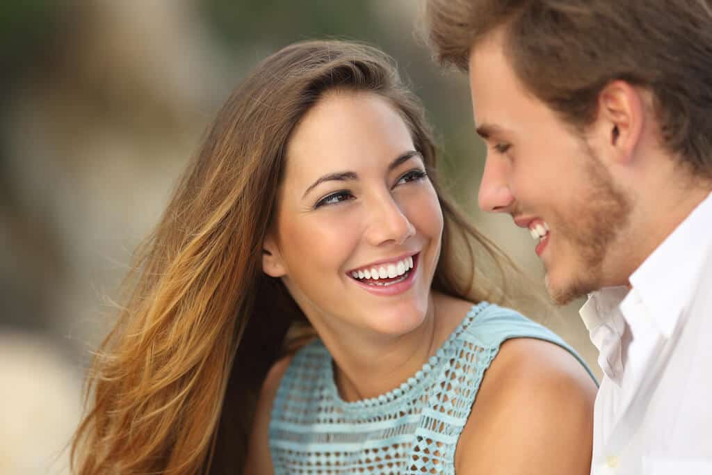 woman smiling at boyfriend asking questions. 